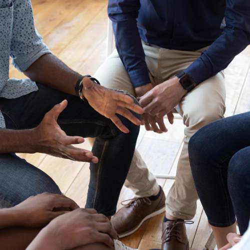 Group talking, focusing on hands