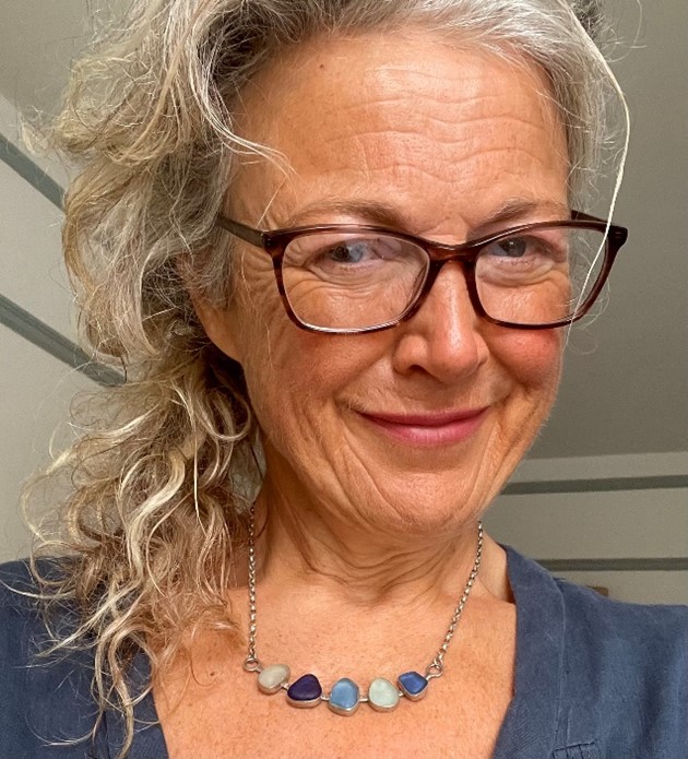 Headshot of image of UKCP's ethics lead Julie Stone, wearing glasses and a blue top.