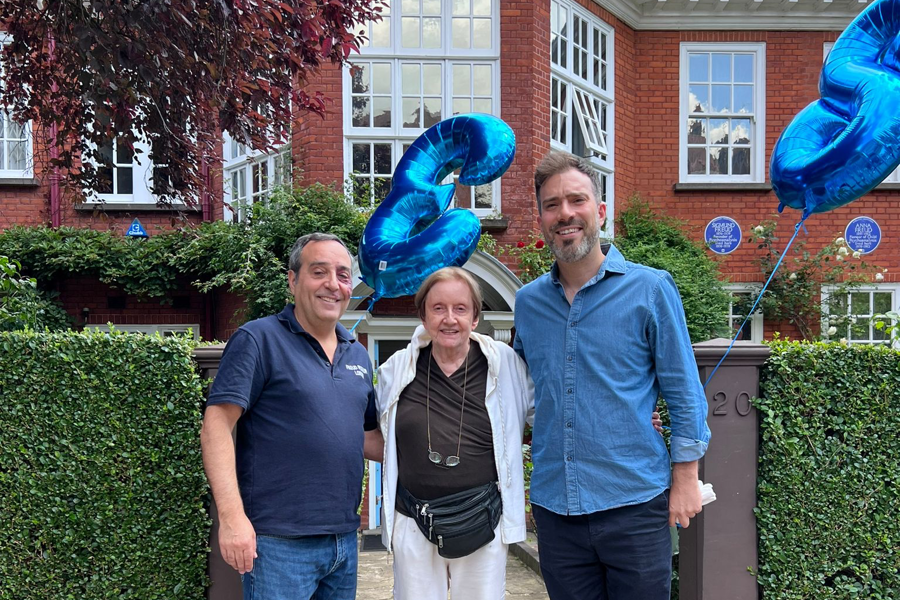 Ann Casement standing in front of the Freud Museum London enterance two with balloons, alongsidestaff members Francisco da Silva and Daniel Bento