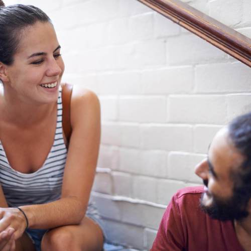 Man And Women Sitting On Stairs Talking