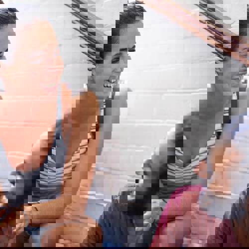 Man And Women Sitting On Stairs Talking.