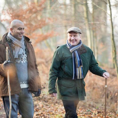 Two men walking in the forest