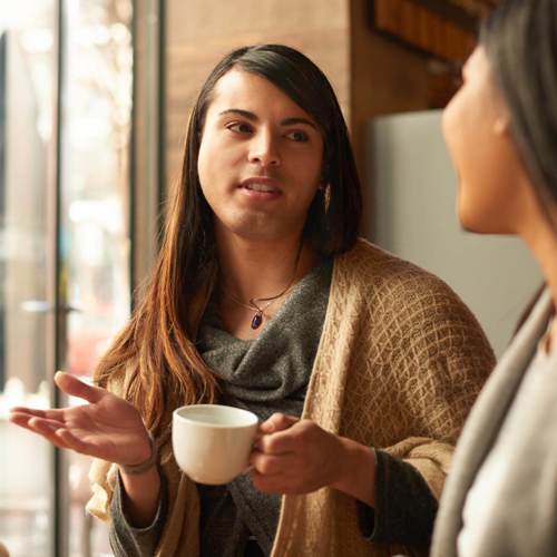 Friends talking while having a coffee break