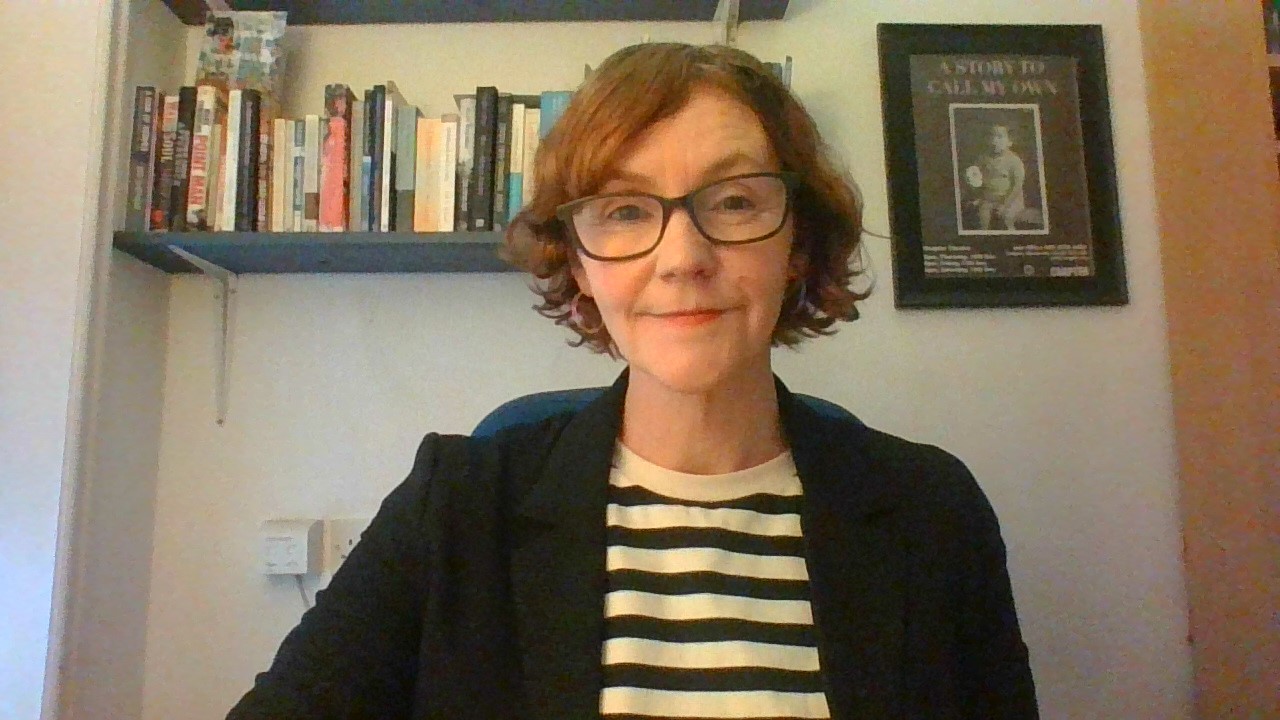 Image of consultative supervisor Alison O’Connor infront of a shelf of books and a framed image.
